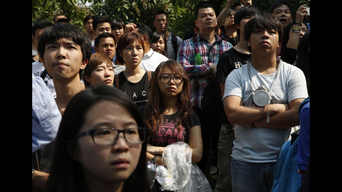 Pro-democracy protesters watch as police remove barricades on October 14.