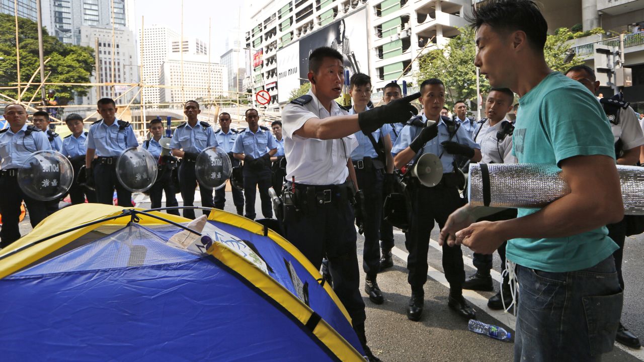 Police ask a protester to leave the main road of Hong Kong's Central district on October 14.