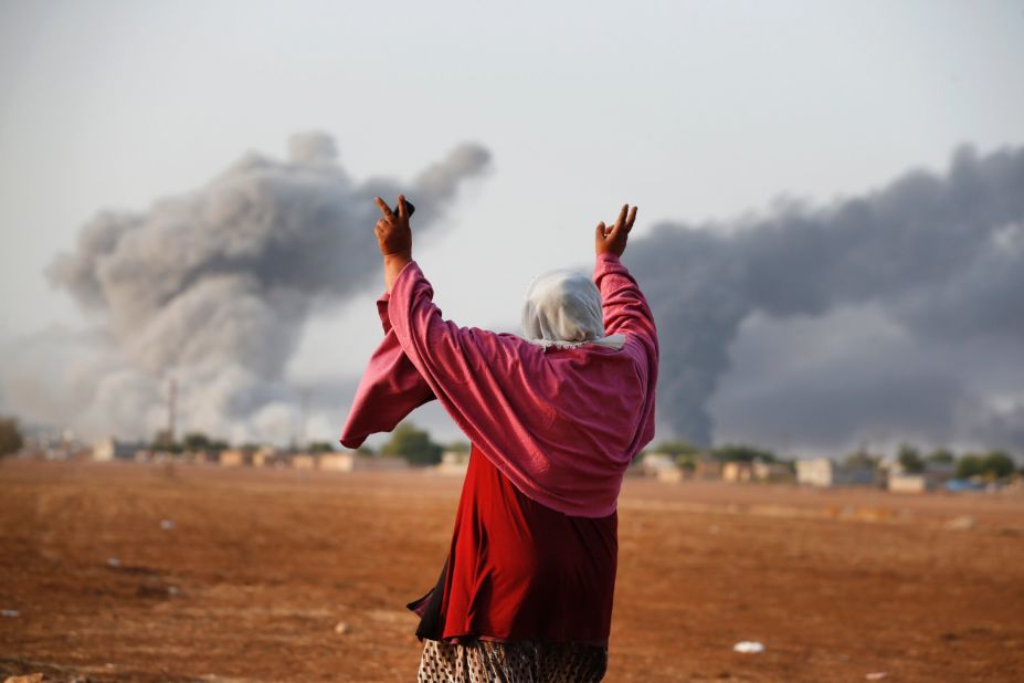 Kiymet Ergun, a Syrian Kurd, celebrates in Mursitpinar, Turkey, after an airstrike by the U.S.-led coalition in Kobani on Monday, October 13.