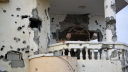 A Palestinian stands on a balcony destroyed in the 50-day conflict between Hamas militants and Israel, in Shejaiya neighbourhood in the east of Gaza city on October 12 ,2014.