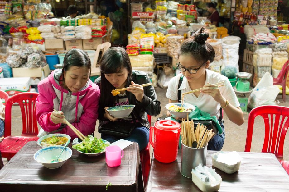 Residents stop for bun bo Hue, an elaborate noodle soup, in Dong Ba Market. Bourdain calls it "the greatest soup in the world." Rice noodles are cooked and served in a spicy, rich broth made from beef and pork bones. It's often accompanied by cubes of congealed pork blood, banana blossoms, scallions and mung bean sprouts.