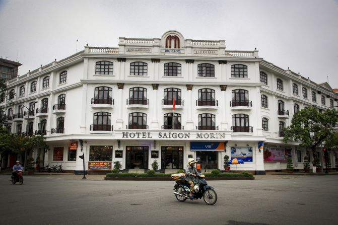 A moped buzzes past Hotel Saigon Morin, a remnant of French architecture in the city.