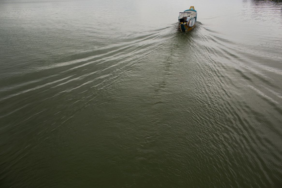 A boat makes ripples near Hue.