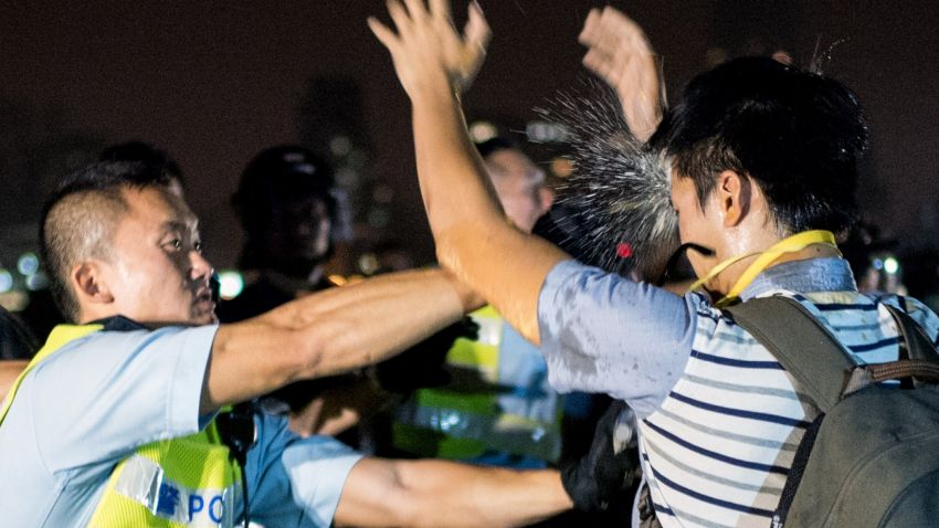A police officer sprays a pro-democracy protester in the face with pepper spray in Hong Kong on October 15, 2014. Hong Kong has been plunged into the worst political crisis since its 1997 handover as pro-democracy activists take over the streets following China's refusal to grant citizens full universal suffrage. AFP PHOTO / ALEX OGLEAlex Ogle/AFP/Getty Images