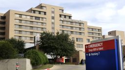 In this Oct. 8, 2014 file photo, a sign points to the entrance to the emergency room at Texas Health Presbyterian Hospital Dallas, where U.S. Ebola patient Thomas Eric Duncan was being treated, in Dallas. The Liberian Ebola patient was left in an open area of the Dallas emergency room for hours, and the nurses treating him worked for days without proper protective gear and faced constantly changing protocols, according to a statement released late Tuesday Oct. 14, 2014 by the largest U.S. nurses' union.