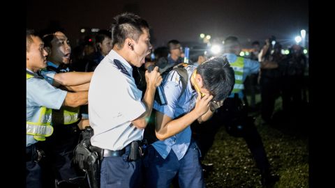 A police officer shouts at a protester who was hit with pepper spray on October 15.