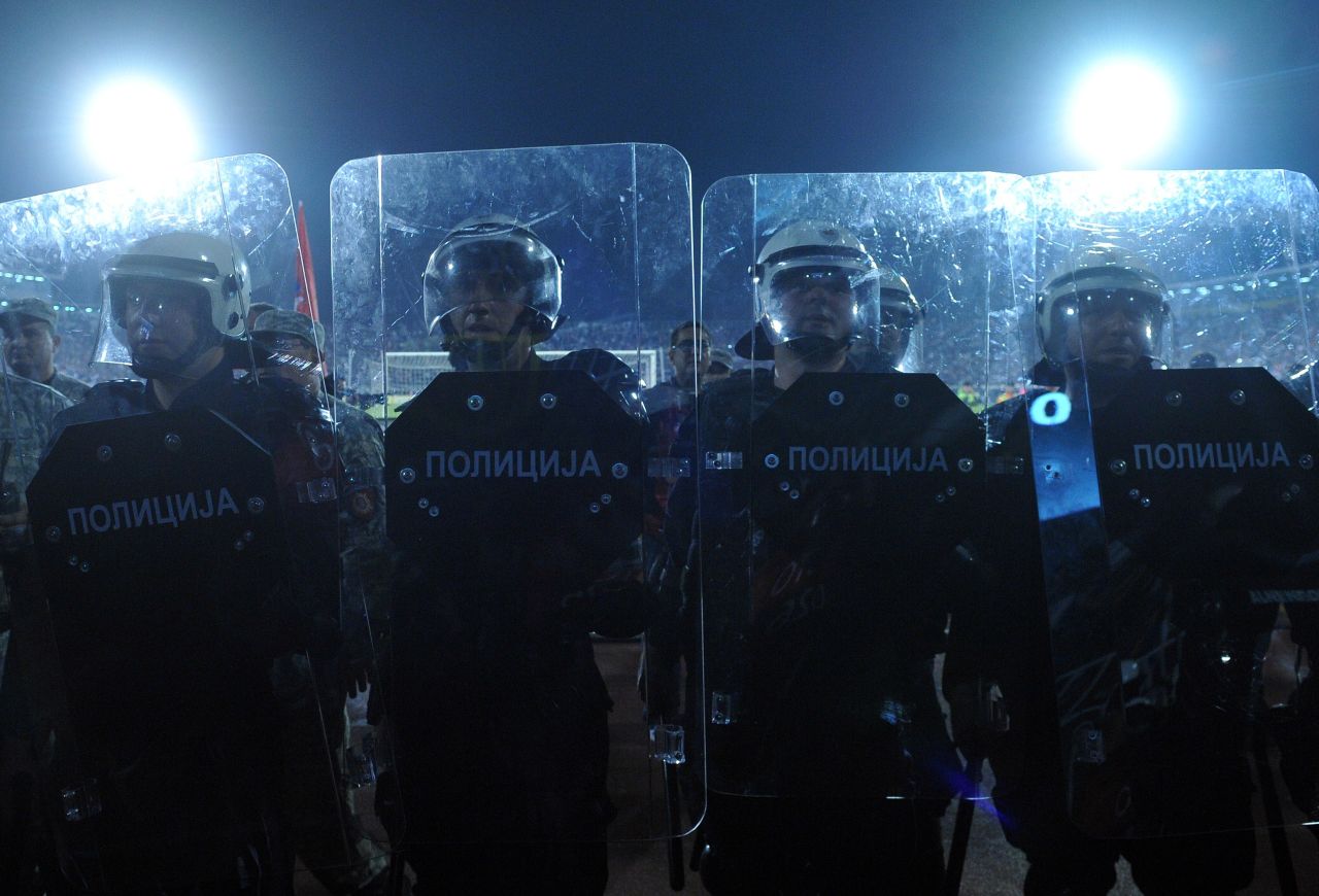 Serbian riot police officers stand guard.