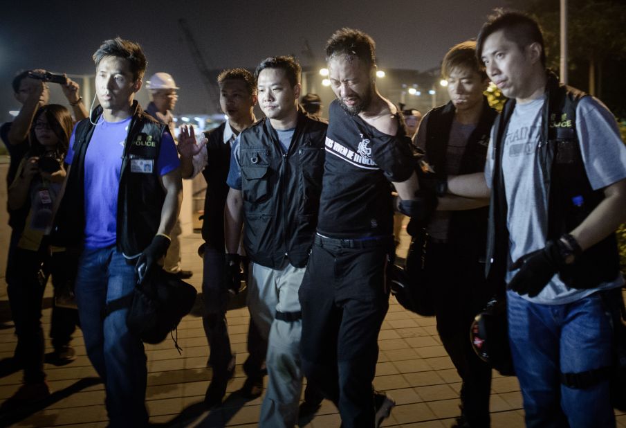 Pro-democracy demonstrator Ken Tsang gets taken taken away by police before allegedly being beaten up in Hong Kong on October 15. Authorities have vowed to conduct an investigation into a widely circulated video that appears to show plainclothes officers kicking and punching the man. 