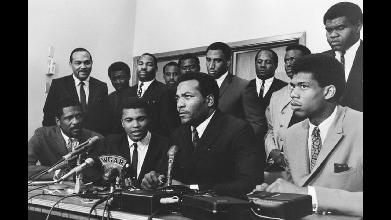As a conscientious objector to the Vietnam War, Ali refused induction into the U.S. Army in April 1967. Here, top athletes from various sports gather to support Ali as he gives his reasons for rejecting the draft. Seated in the front row, from left to right, are Bill Russell, Ali, Jim Brown and Kareem Abdul-Jabbar.