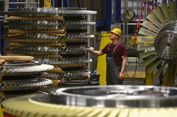 Siemens, the German engineering and electronics company, has its headquarters in Berlin and also happens to be Europe's largest engineering company. A worker, pictured, stands among rotor assemblies at the Siemens gas turbine factory in Berlin.
