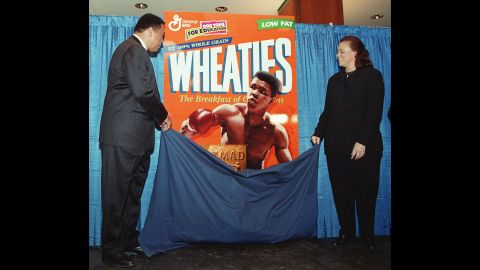 Ali and his fourth wife, Lonnie, unveil his special-edition Wheaties box in February 1999. The box marked the cereal's 75th anniversary, and it was the first time a boxer appeared on the cover.