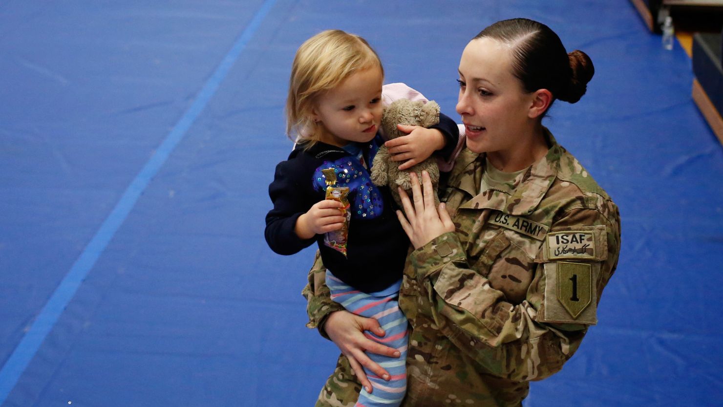 U.S. Army Sgt. Michelle Porter holds her daughter after a homecoming ceremony in Fort Knox, Kentucky, in November 2013. 
