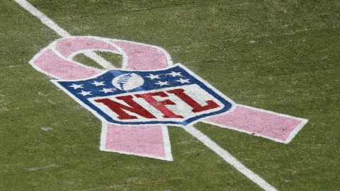 The NFL logo for breast cancer awareness adorns the field  in Florida as the Miami Dolphins play the Green Bay Packers.