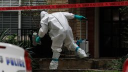 A man dressed in protective hazmat clothing treats the front porch of an apartment where a second person diagnosed with the Ebola virus resides in Dallas, Texas, on Sunday, October 12. A female nurse working at Texas Heath Presbyterian Hospital, the same facility that treated Thomas Eric Duncan, has tested positive for the virus.