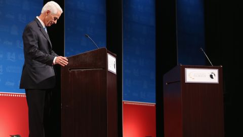 Caption:DAVIE, FL - OCTOBER 15: Former Florida Governor and Democratic candidate for Governor Charlie Crist waits next to an empty podium for Republican Florida Governor Rick Scott who delayed his entry onto the stage due to an electric fan that Crist had at his podium as they participate in a televised debate at Broward College on October 15, 2014 in Davie, Florida. Governor Scott is facing off against Crist in the November 4, 2014 governors race. (Photo by Joe Raedle/Getty Images)

