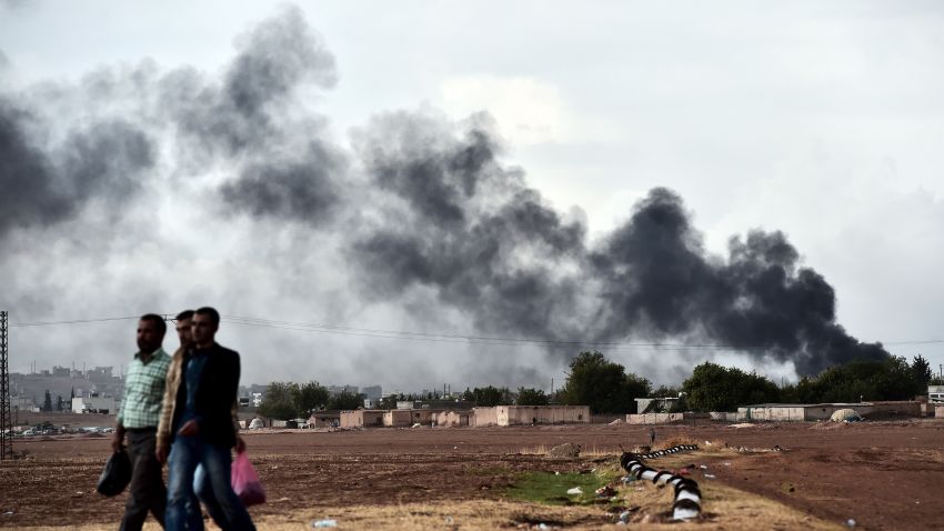 Kurdish men walks close to the Turkish-Syrian border as smoke rises from the Syrian town of Kobane, also known as Ain al-Arab, as seen from the southeastern village of Mursitpinar, in the Sanliurfa province, on October 16, 2014. Turkey's ruling party said it was optimistic about the prospects for the peace process with Kurdish rebels after a spate of violence raised concern about its viability. AFP PHOTO / ARIS MESSINIS (Photo credit should read ARIS MESSINIS/AFP/Getty Images)
