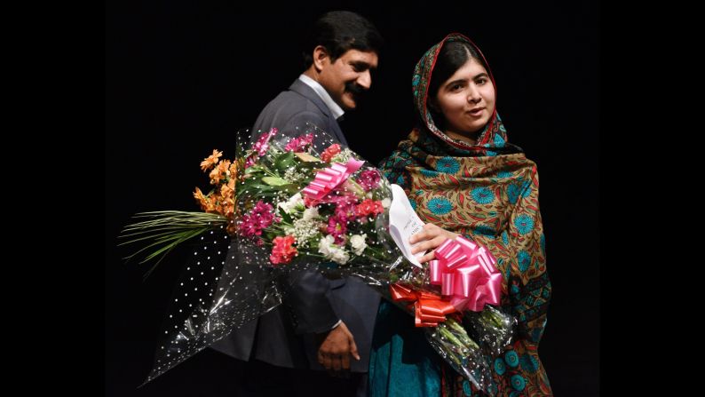 Malala Yousafzai holds flowers on a stage in Birmingham, England, after she was announced as <a href="http://www.cnn.com/2014/10/10/world/europe/nobel-peace-prize/index.html">a recipient of the Nobel Peace Prize</a> on Friday, October 10. Two years ago, the 17-year-old was shot in the head by the Taliban for her efforts to promote education for girls in Pakistan. Since then, after recovering from surgery, she has taken <a href="http://www.cnn.com/2013/10/10/world/gallery/malala-yousufzai/index.html">her campaign</a> to the world stage.