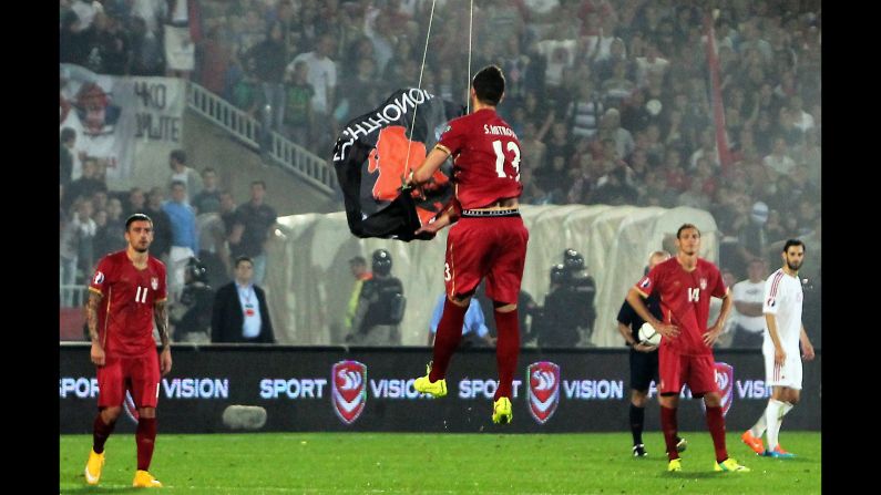 Serbian soccer player Stefan Mitrovic grabs a flag with Albanian symbols on it as a drone carried it over the field during a Euro 2016 qualifying match Tuesday, October 14, in Belgrade, Serbia. The incident <a href="http://www.cnn.com/2014/10/14/sport/football/serbia-albania-game-abandoned/index.html">set off a brawl</a> between players on both the Serbian and Albanian teams, and the match was abandoned after 41 minutes. There was already tension going into the match because Serbia does not recognize Kosovo, a former Serbian province that declared independence in 2008.