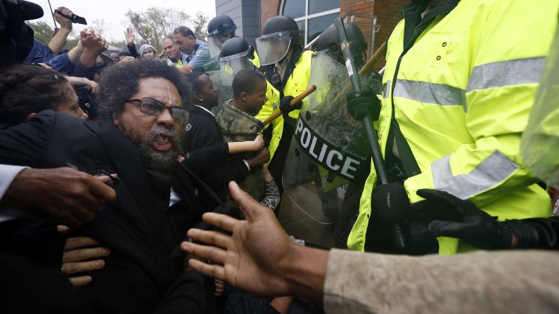 Activist Cornel West is knocked over during a scuffle with police Monday, October 13, in Ferguson, Missouri. Police said West and 42 others <a href="http://www.cnn.com/2014/10/13/us/ferguson-protests/index.html">were detained</a> for disturbing the peace during the "Moral Monday" march. Demonstrators were demanding the arrest of Darren Wilson, the Ferguson police officer who fatally shot teenager Michael Brown in August.