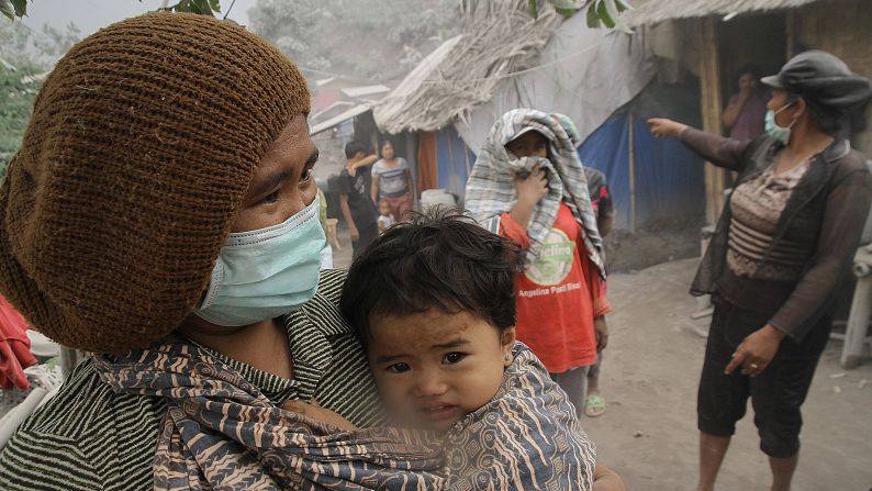 Villagers wear masks Sunday, October 12, to protect themselves from the thick volcanic ash created by the eruption of Mount Sinabung in Indonesia.