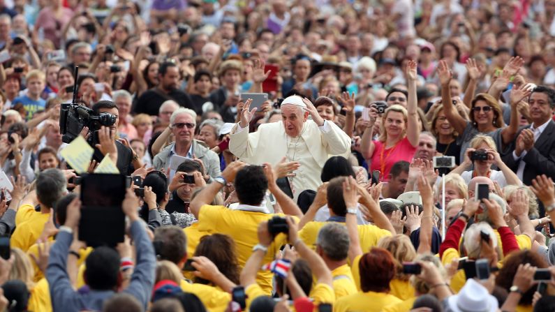 Pope Francis interacts with the faithful during his weekly audience Wednesday, October 15, at St. Peter's Square in Vatican City.