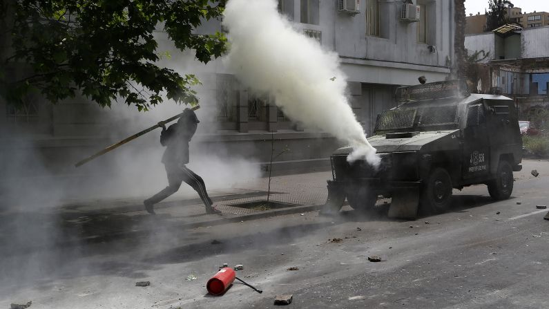A Mapuche Indian activist in Santiago, Chile, clashes with riot police during a protest against Columbus Day on Sunday, October 12. Many indigenous people in Latin America do not have a positive view of Columbus Day, saying Columbus brought slavery, disease, colonization and genocide from Europe to the Americas.