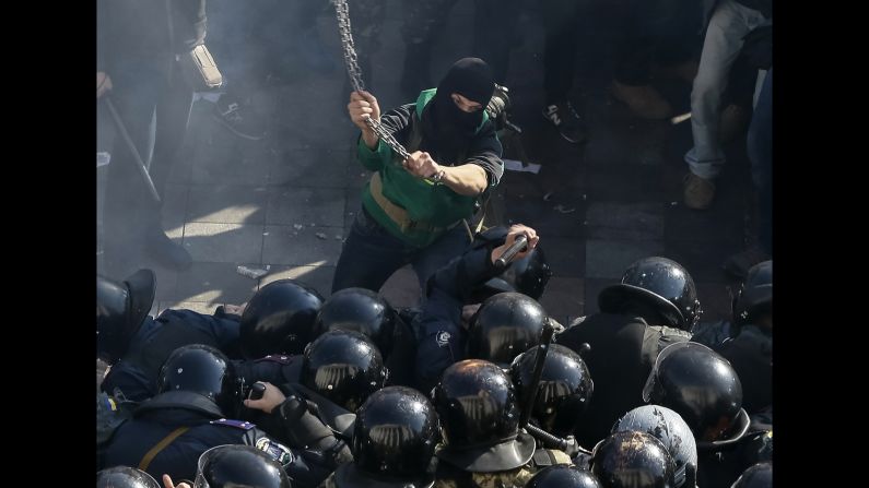 A protester clashes with law enforcement members near the parliament building in Kiev, Ukraine, on Tuesday, October 14. Protesters were demanding the release of political prisoners in Ukraine.