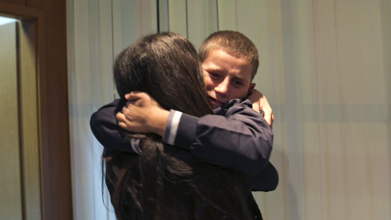 Pranvera Abazi kisses her son Erion Zena during their reunion at Kosovo's main airport on Wednesday, October 15. Kosovo's Prime Minister said the country's intelligence and security forces returned the 8-year-old ethnic Albanian after his jihadi father took him to Syria.