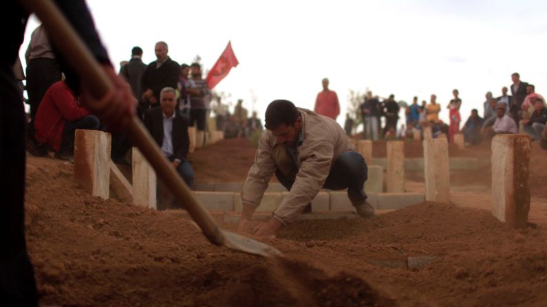 Cundi Minaz, a female Kurdish fighter, is buried in a cemetery in the southeastern Turkish town of Suruc on Tuesday, October 14. Minaz was reportedly killed during clashes with ISIS militants in nearby Kobani, Syria. Civil war has destabilized Syria and created an opening for <a href="http://www.cnn.com/2014/06/13/world/gallery/iraq-under-siege/index.html">the ISIS militant group</a>, which is also advancing in Iraq as it seeks to create an Islamic caliphate in the region.