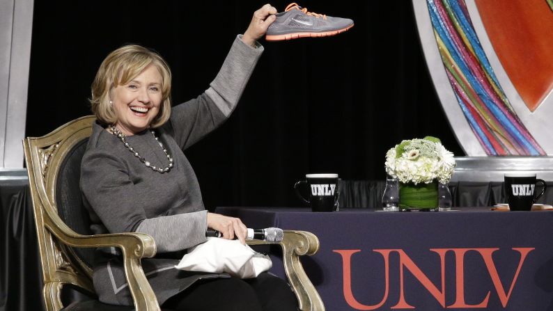 Former U.S. Secretary of State Hillary Clinton holds up a shoe Monday, October 13, during the UNLV Foundation's annual dinner in Las Vegas. The shoe was given to Clinton by Brian Greenspun, who is the CEO, publisher and editor of the Las Vegas Sun newspaper. A woman threw a shoe at Clinton during an appearance in Las Vegas in April.