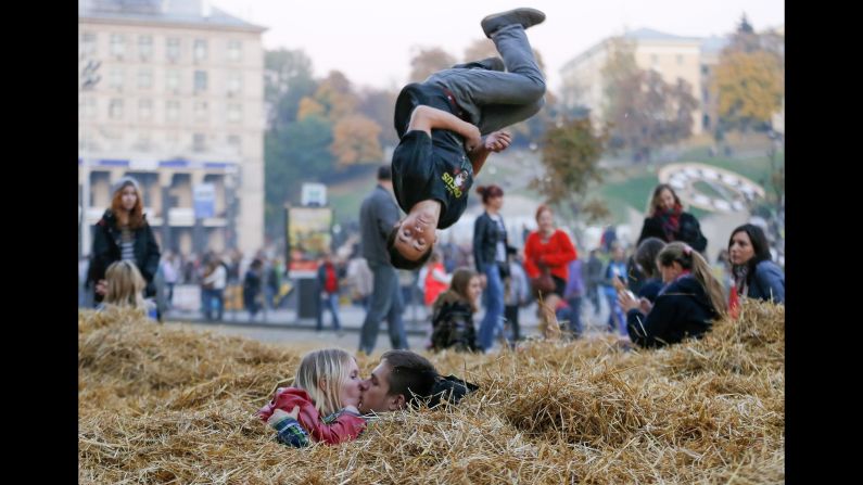 A couple kisses on a pile of hay Sunday, October 12, at Independence Square in Kiev, Ukraine. The hay was leftover from a folk fair the previous day.