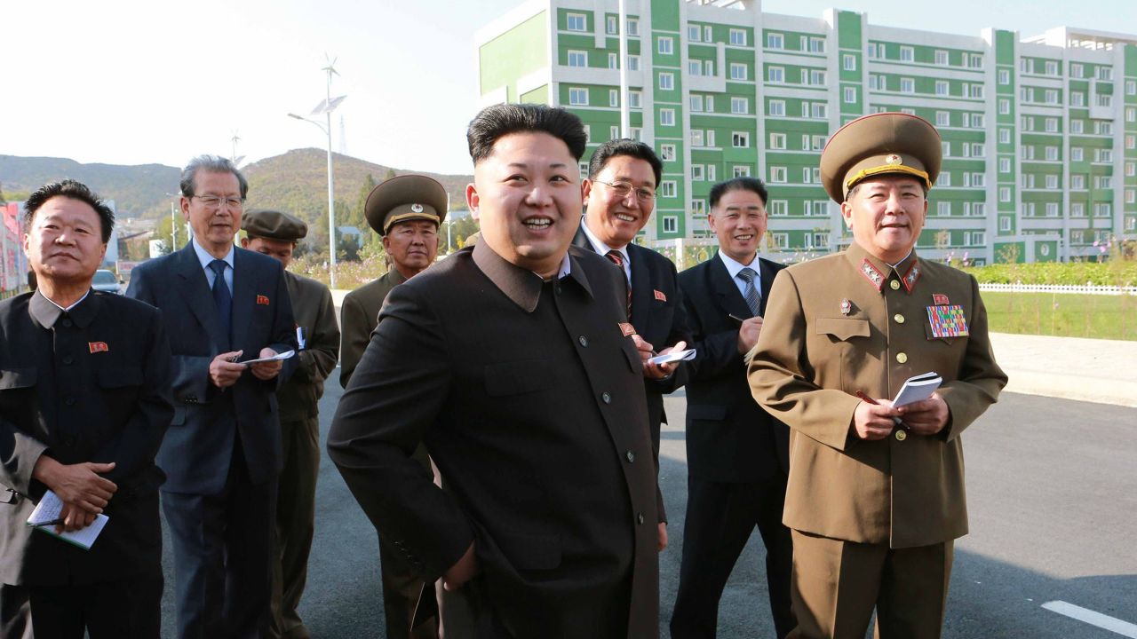 This undated picture released from North Korea's official Korean Central News Agency (KCNA) on October 14, 2014 shows North Korean leader Kim Jong-Un (C) smiling as he inspects a newly-built housing complex in Pyongyang. AFP PHOTO / KCNA via KNS REPUBLIC OF KOREA 