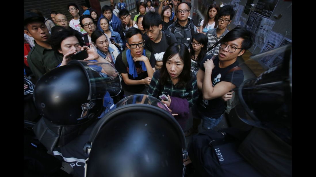 Riot police clear out an encampment of protesters on October 17. Police swooped in early to dismantle the protest campsite.