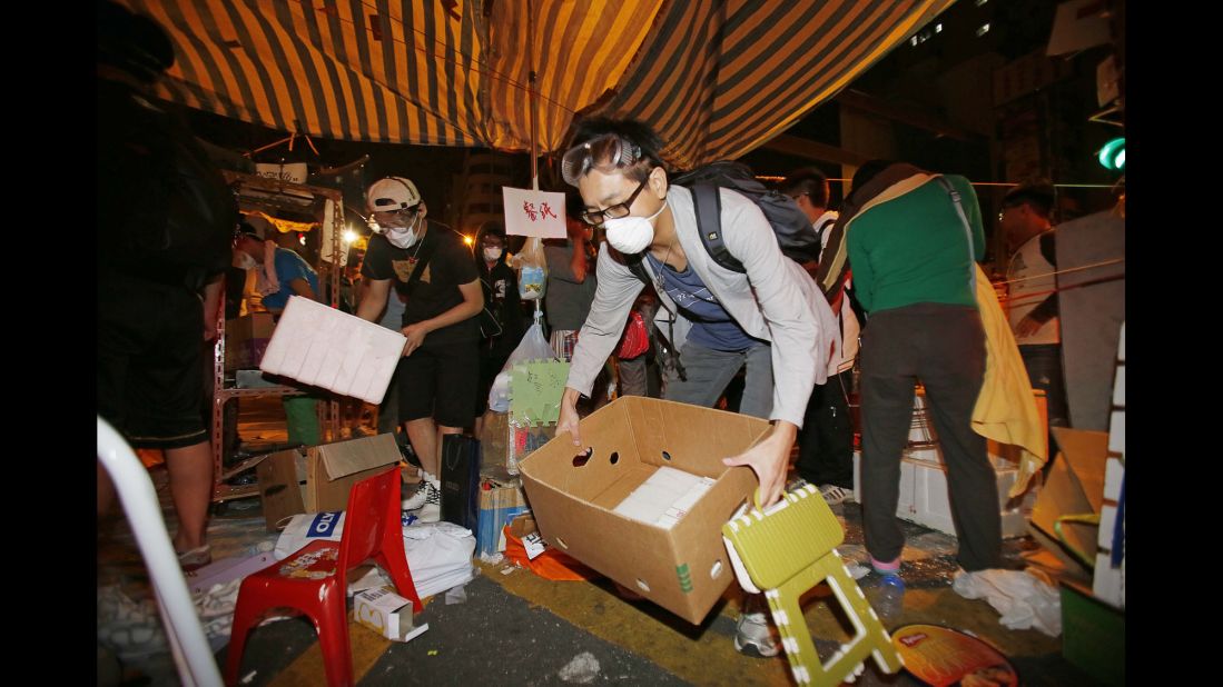 Demonstrators remove their belongings from a protest camp early on October 17.