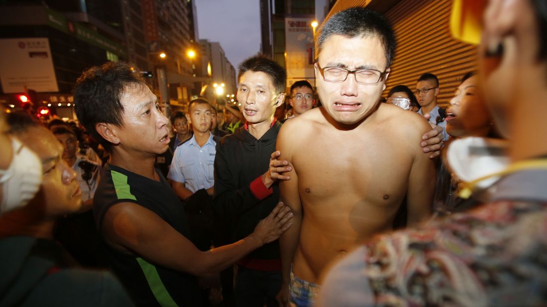 Pro-democracy protesters break down as riot police clear their camp October 17.