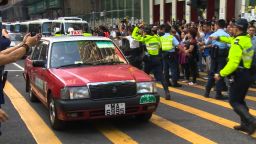 Hong Kong police allow cars to roll down Nathan Street in the Mong Kok business district, October 17, 2014.