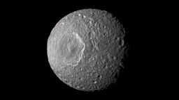 This mosaic of Saturn's moon Mimas was created from images taken by NASA's Cassini spacecraft during its closest flyby of the moon in February 2010. A new study suggests that the moon is either shaped like a football or it contains a liquid water ocean.