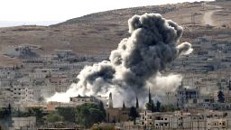 Heavy smoke rises following an airstrike by the US-led coalition aircraft in Kobani, Syria, during fighting between Syrian Kurds and the militants of Islamic State group, as seen from the outskirts of Suruc, on the Turkey-Syria border, October 15, 2014.
