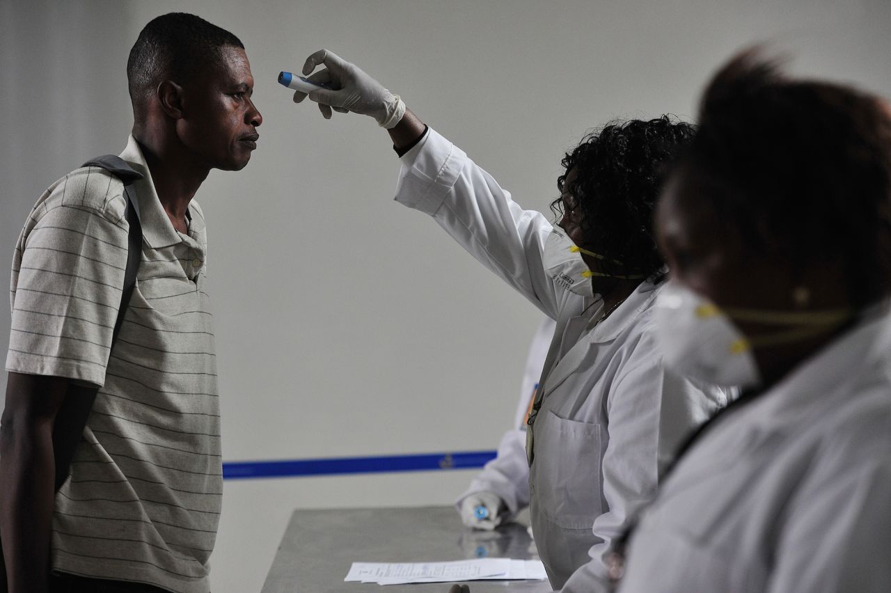 Kenyan health officials take passengers' temperatures as they arrive at the Jommo Kenyatta International Airport in Nairobi in August. According to the WHO, there have been no reported cases of Ebola in Kenya to date, though the country's role as a transportation hub in East Africa makes it vulnerable to the disease. 