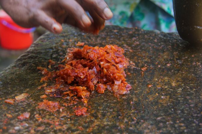 One of the most common ways to garnish kiribath is with lunu miris, a sambol chili sauce ground into a paste.
