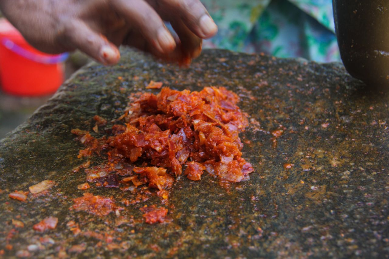 One of the most common ways to garnish kiribath is with lunu miris, a sambol chili sauce ground into a paste.