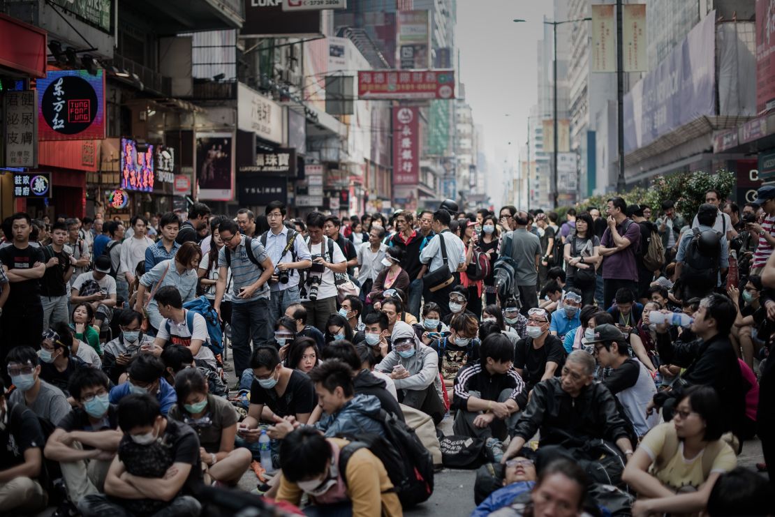 Pro-democracy protesters stand their ground in the financial district of Hong Kong on October 17, 2014. 