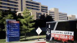 A trailer with Hazardous Materials signage being pulled by a truck drives past Texas Health Presbyterian Hospital Dallas on its way to the the loading docks nearby, Thursday, Oct. 16, 2014, in Dallas. (AP Photo/Tony Gutierrez)