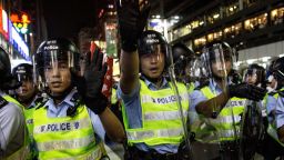 Police officers yell at pro-democracy protesters as they push forward in an attempt to clear a street in Hong Kong's Mong Kok district on Saturday, October 18.