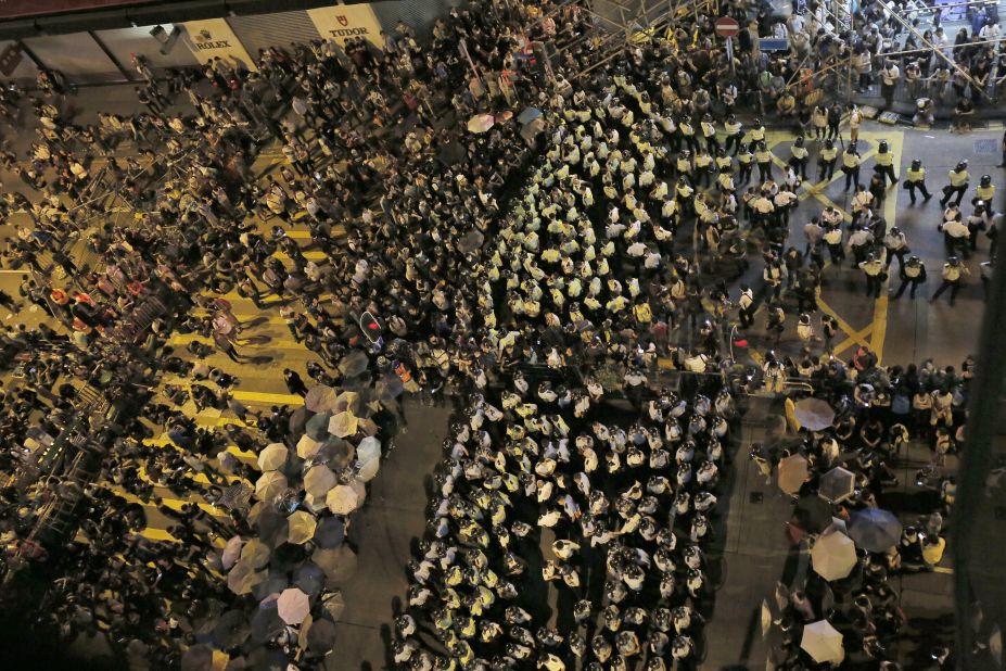 Protesters and riot police officers face off at a main road on October 17.