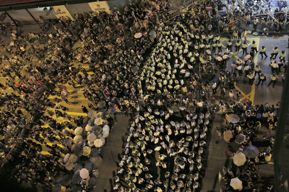 Protesters and riot police officers face off at a main road on October 17. 