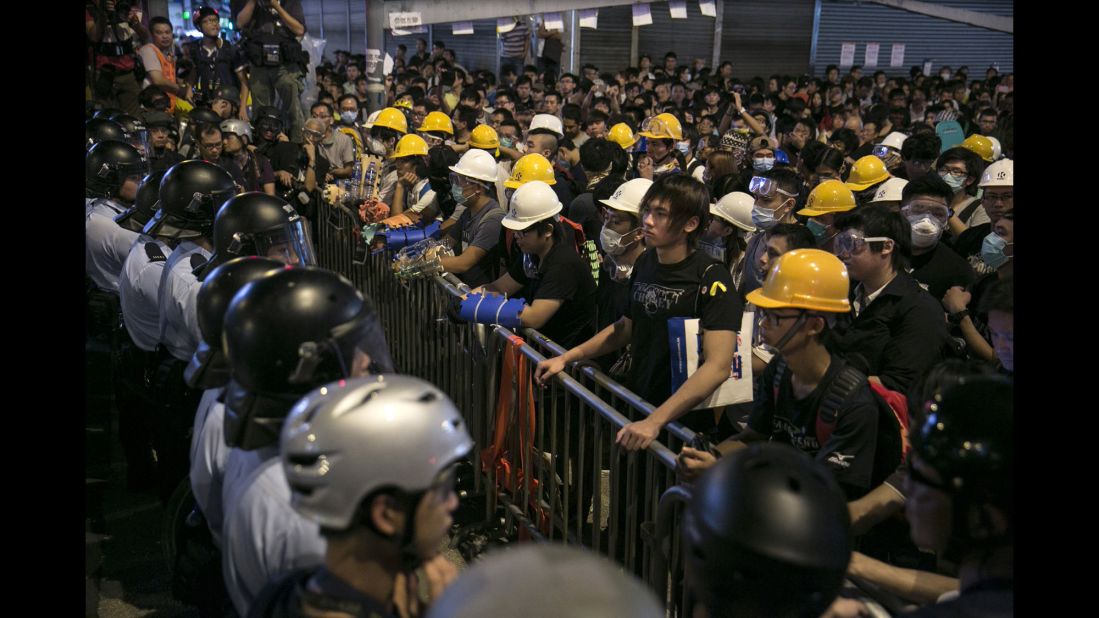 Police and protesters face each other across a barricade as tensions continue in Hong Kong on Monday, October 20.