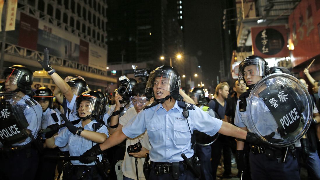 Riot police advance on a pro-democracy protest encampment early Sunday, October 19.