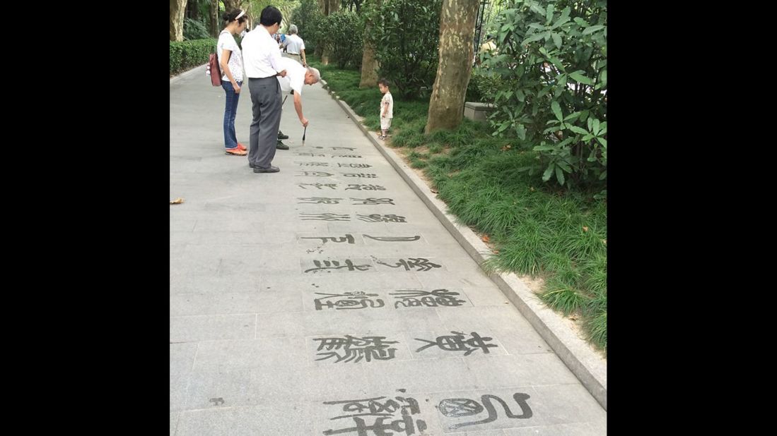 A man does calligraphy in Fuxing Park in the former French Concession area of Shanghai. "It's so cool that in the shadows of the ultramodern Shanghai and Oriental Pearl (Tower) are people in the parks doing calligraphy or playing mahjong," said <a href="http://instagram.com/p/sv-_DuERlL" target="_blank" target="_blank">Beth Cassar</a>, who snapped this photo.