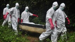 A burial team in protective gear carry the body of woman suspected to have died from Ebola virus in Monrovia, Liberia. Saturday, Oct, 18, 2014. The death toll from Ebola will rise this week to more than 4,500 people from the 9,000 infected and the outbreak is still out of control in three West African nations, a top official with the U.N. health agency said   (AP Photo/Abbas Dulleh)